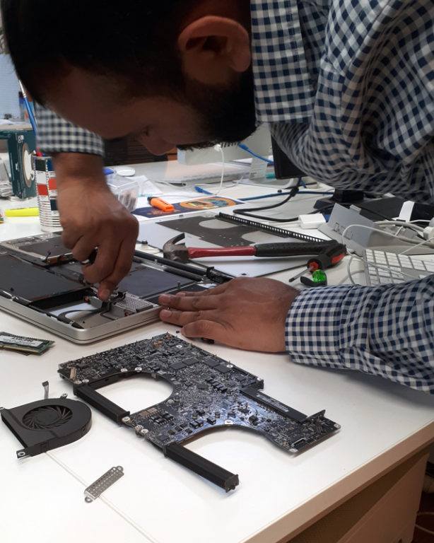 Developer Sanjay breaking up old computer parts to make the letter 'R'
